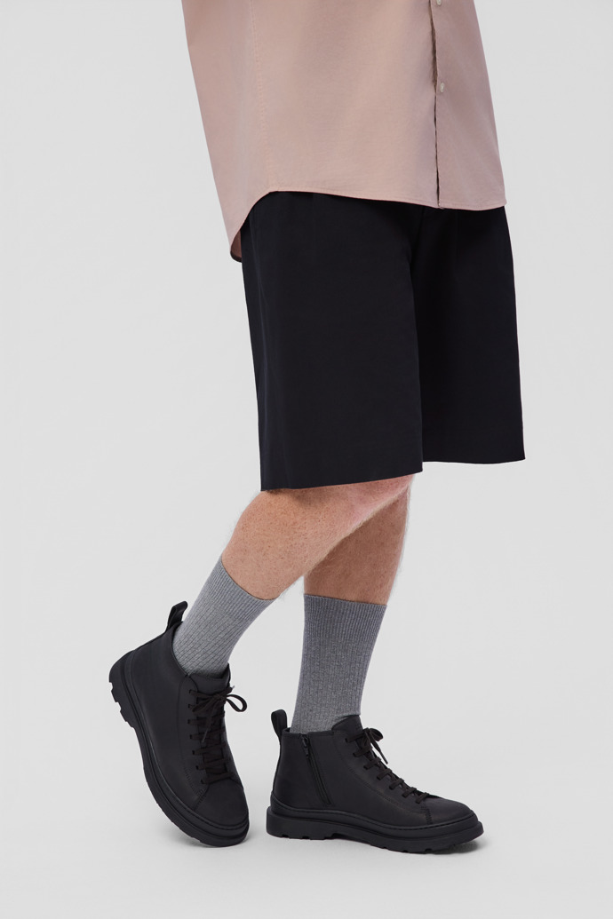 A model wearing Brutus+ Black Nubuck Ankle Boots for Men.
