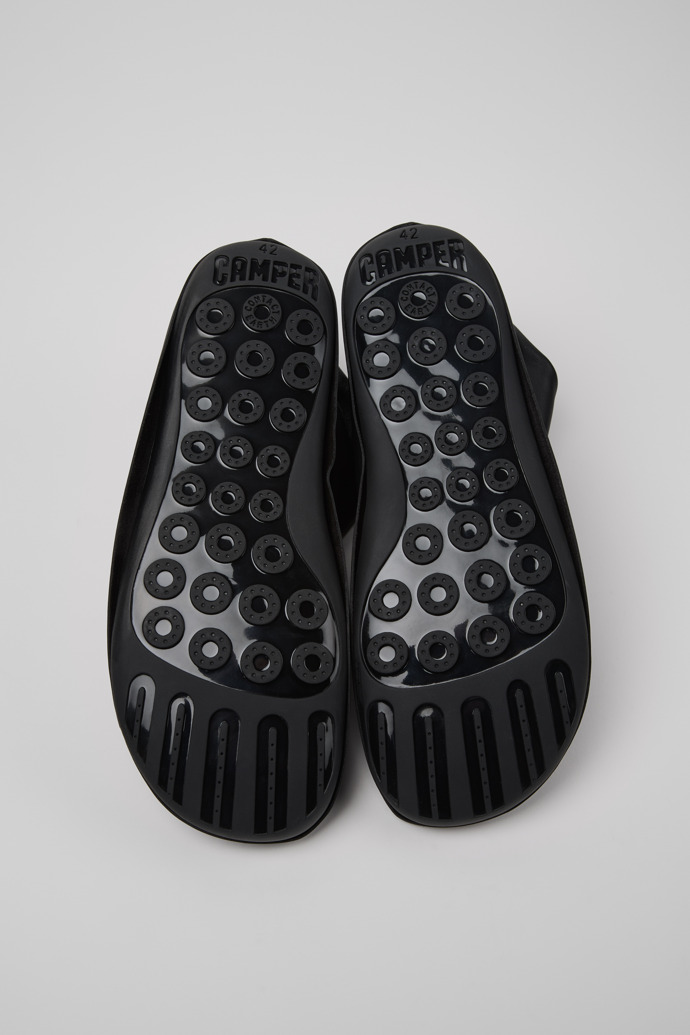 The soles of Camper x ISSEY MIYAKE - Peu Form Black Leather Ankle Boots for Men.