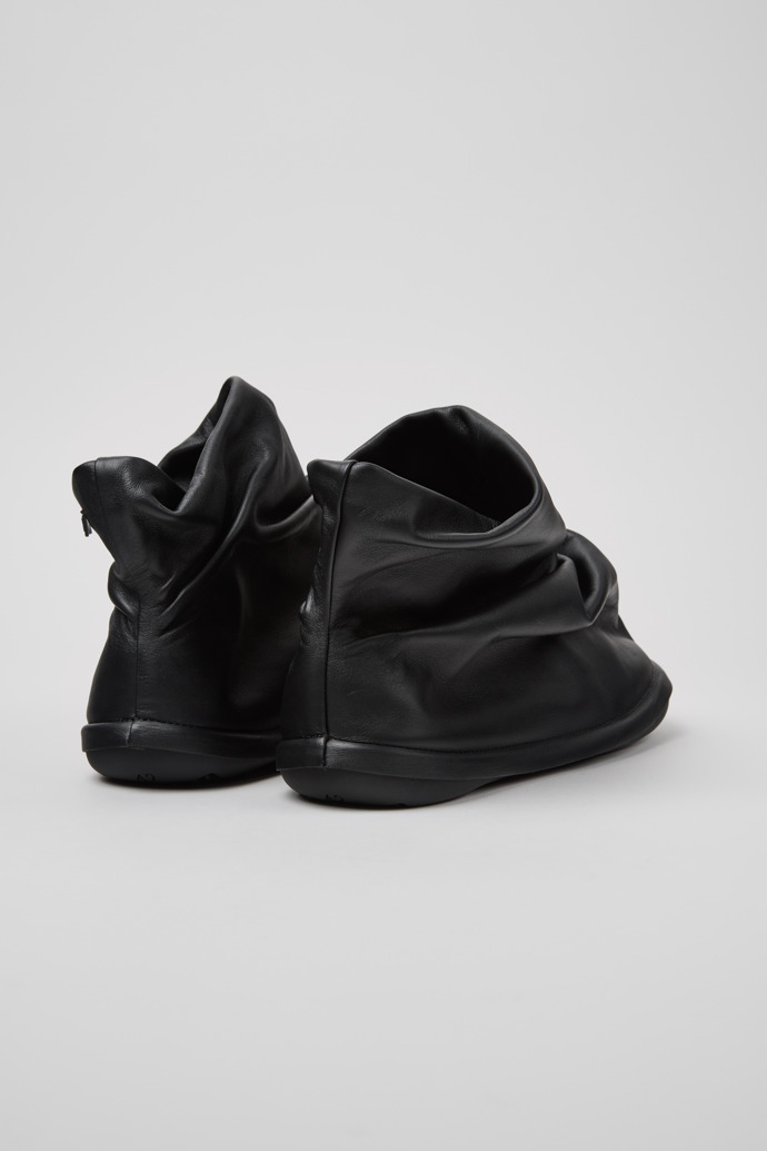 Back view of Camper x ISSEY MIYAKE - Peu Form Black Leather Ankle Boots for Men.