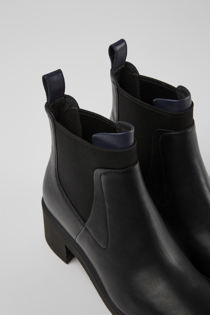 Close-up view of Wonder Black and blue leather ankle boots for women