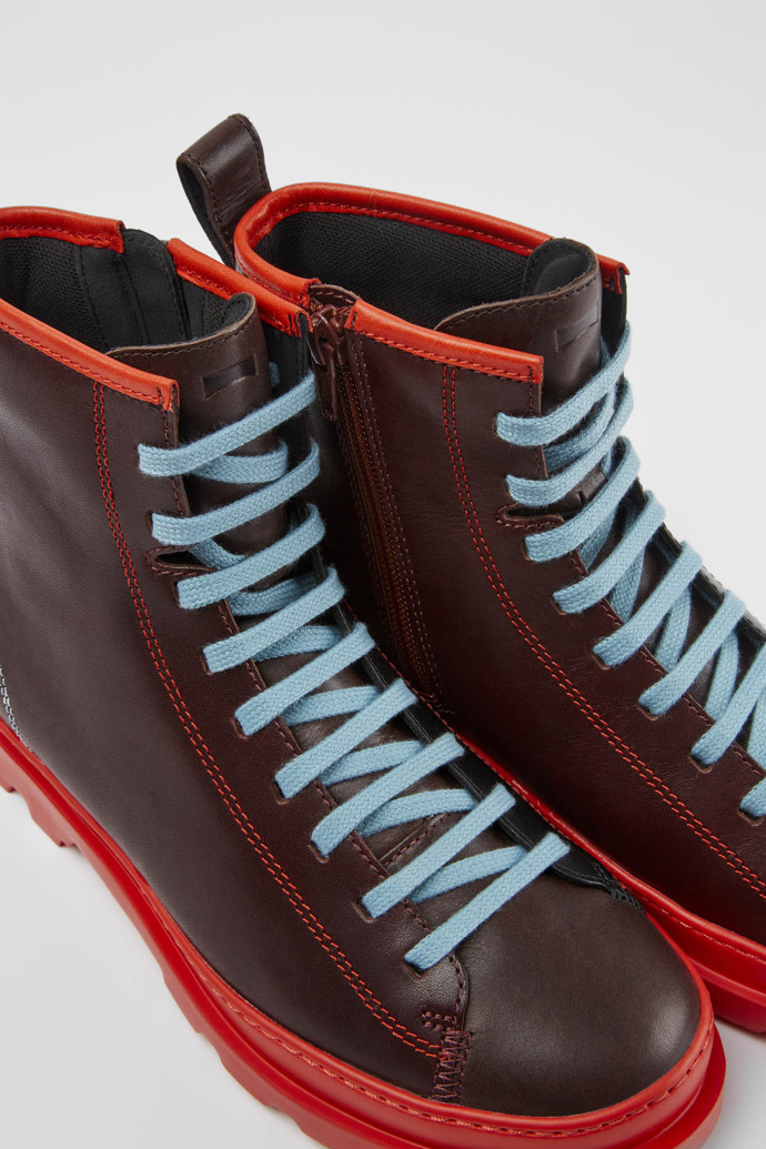 Close-up view of Twins Red, brown and black boots for women