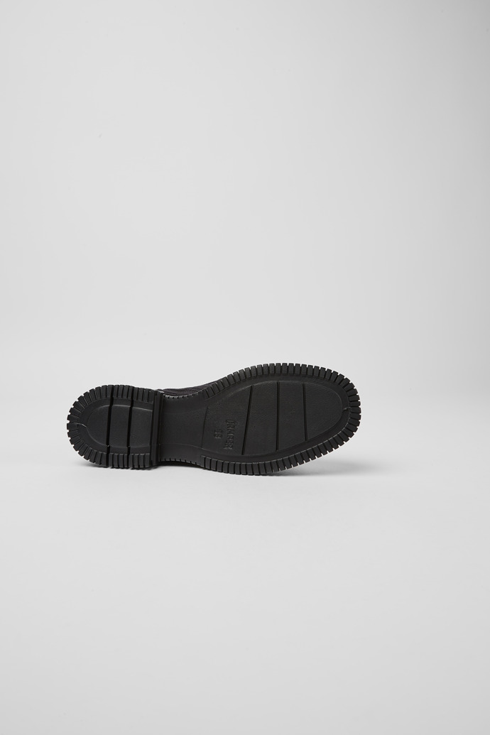 The soles of Pix Black zip boots for women