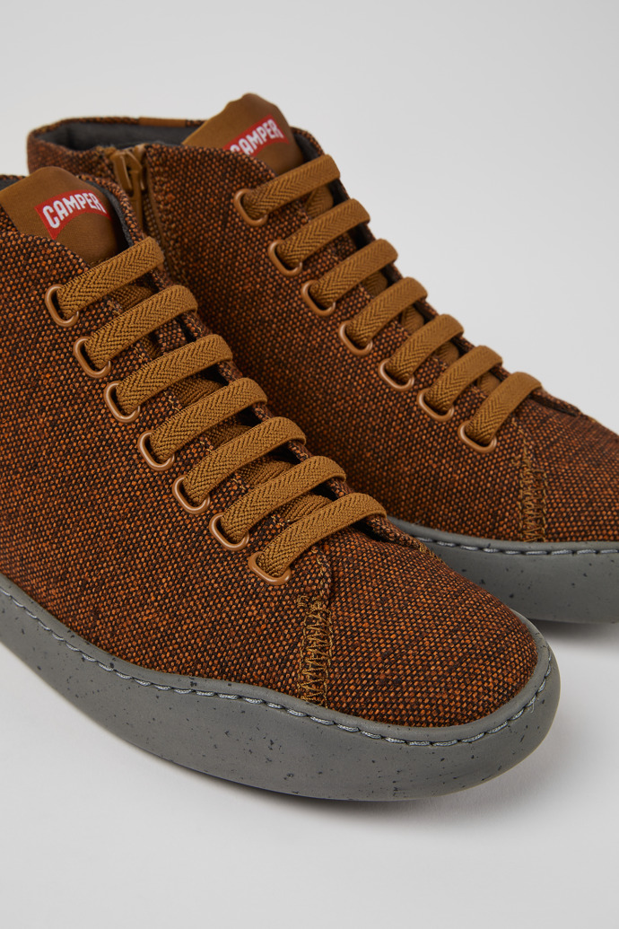 Close-up view of Peu Touring Brown and black recycled wool sneakers for women