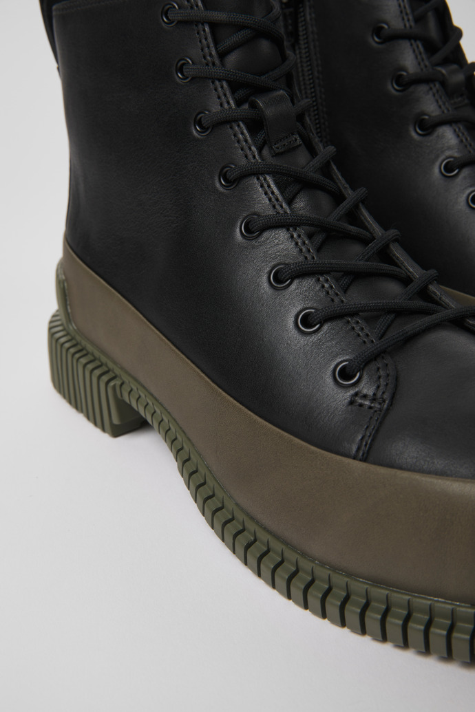 Close-up view of Pix Black and green leather ankle boots for women