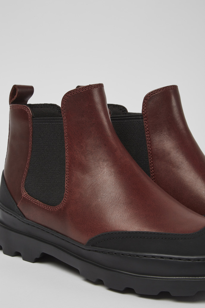 Close-up view of Brutus Black and burgundy ankle boots for women