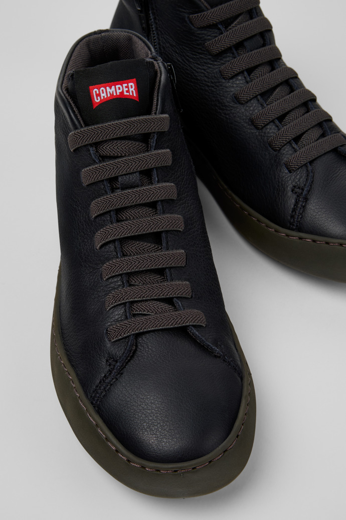 Close-up view of Peu Touring Black Leather Sneaker Booties for Women.