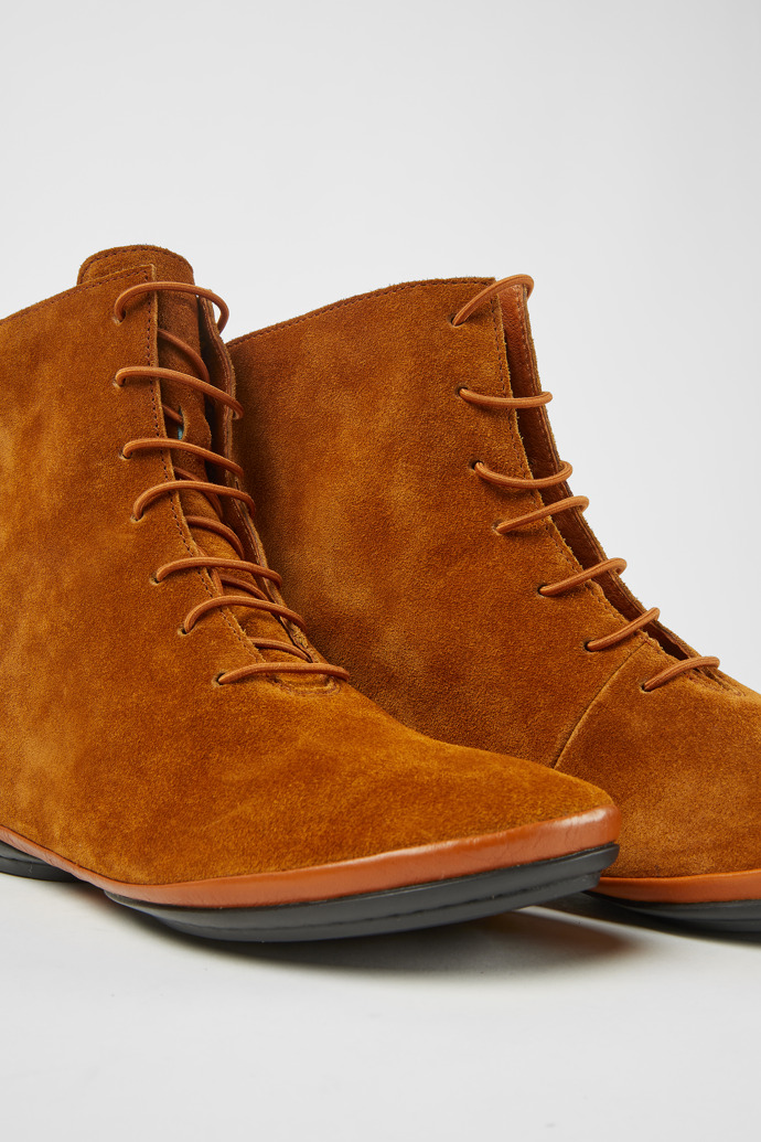 Close-up view of Right Brown suede ankle boots