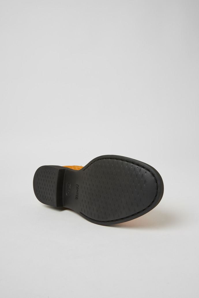 The soles of Iman Orange nubuck ankle boots