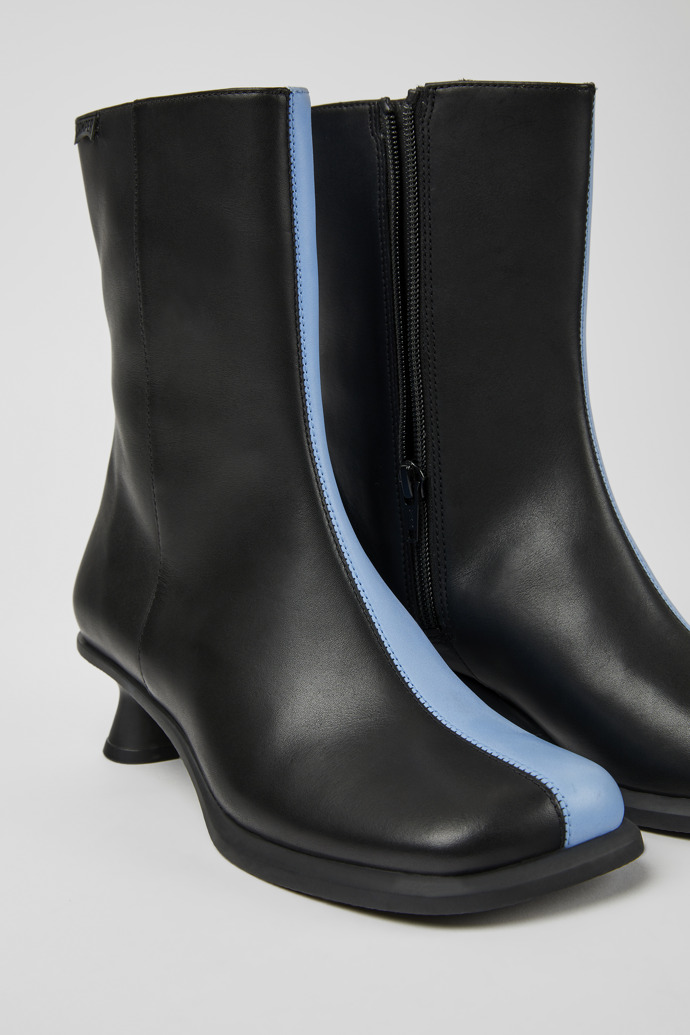 Close-up view of Twins Blue and black leather ankle boots for women