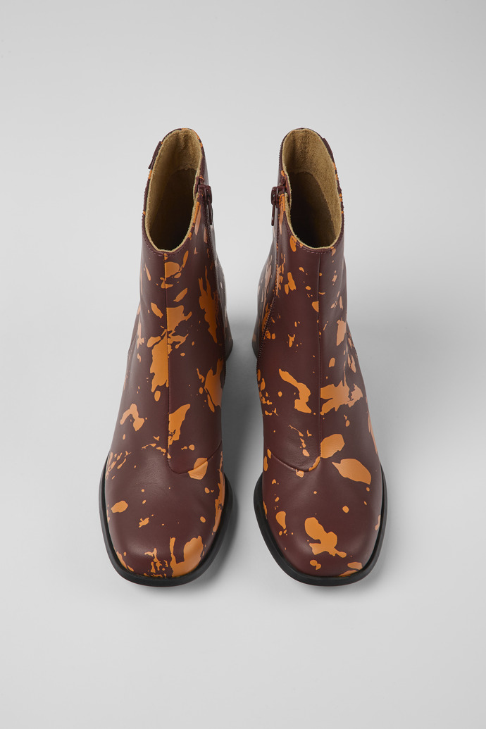 Overhead view of Kiara Burgundy and orange printed leather ankle boots