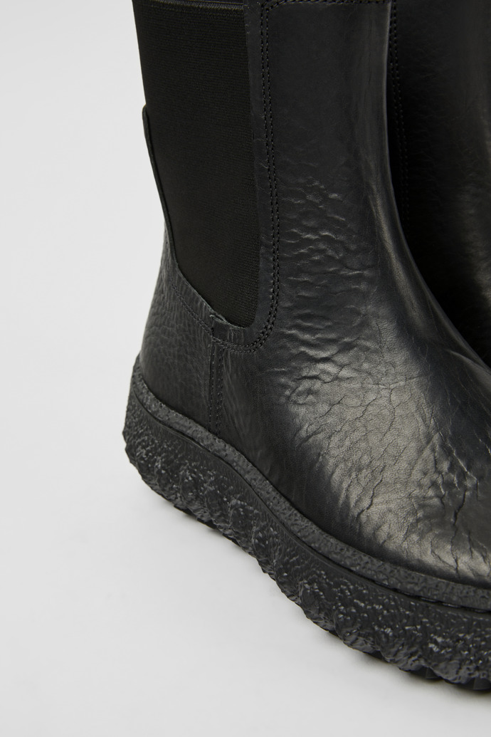 Close-up view of Ground Black leather ankle boots for women