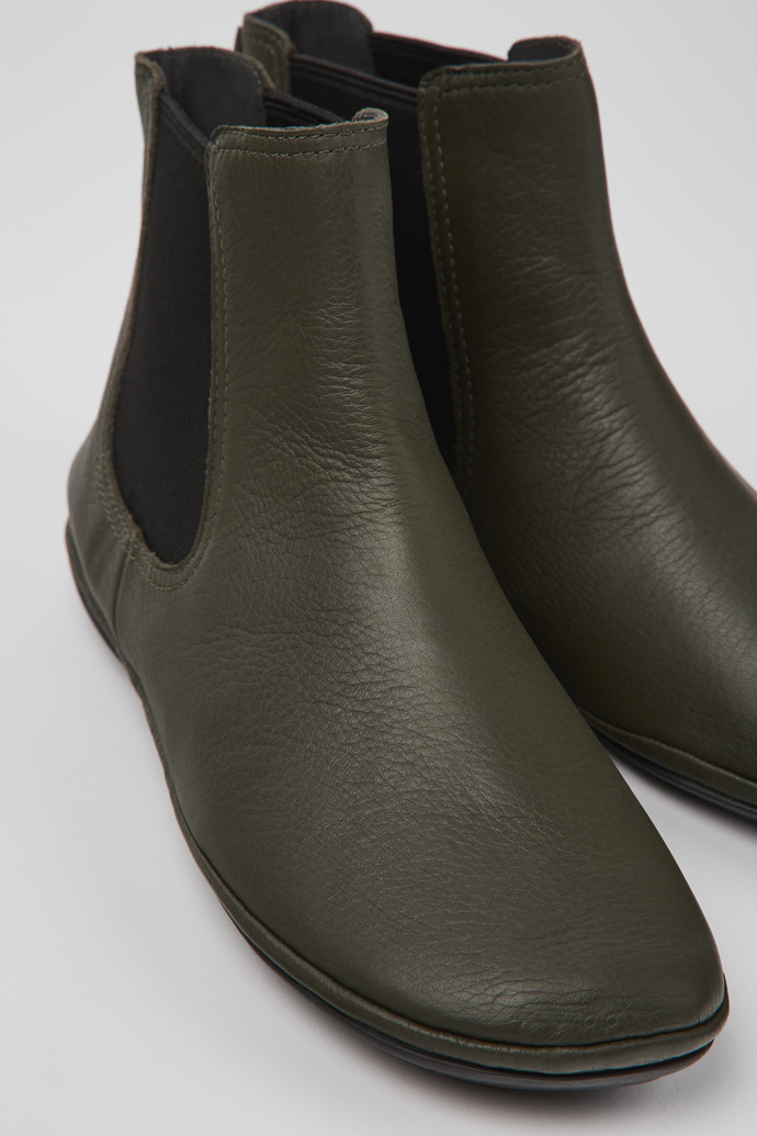 Close-up view of Right Green leather ankle boots