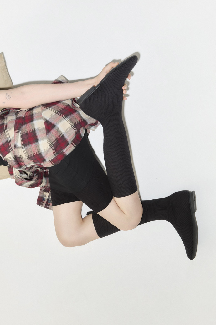 A model wearing Casi Myra - TENCEL Black TENCEL™ Lyocell High Boots for Women.