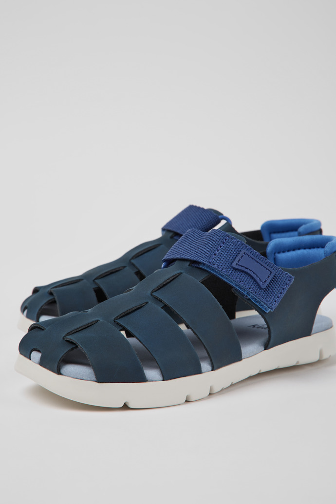 Close-up view of Oruga Blue leather sandals for kids