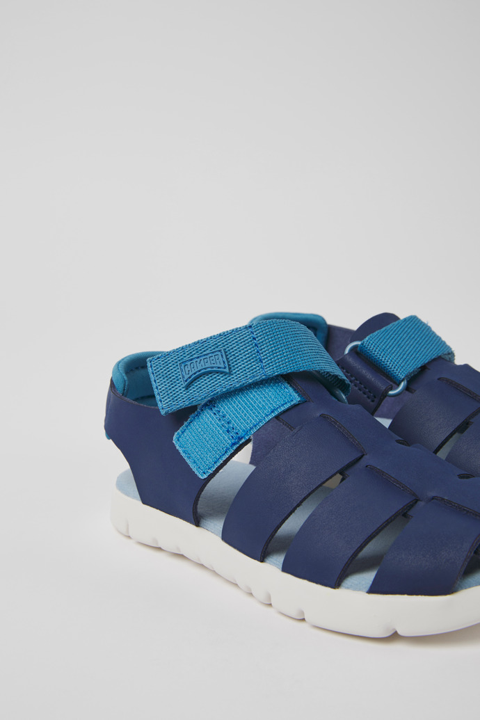 Close-up view of Oruga Blue leather sandals for kids