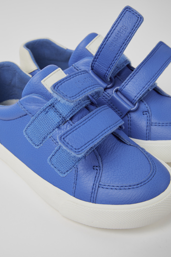 Close-up view of Pursuit Blue and white sneakers for kids