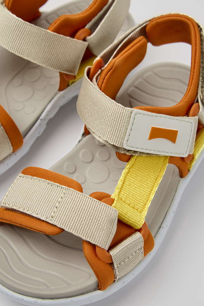 Close-up view of Wous Yellow, orange, and beige sandals for kids