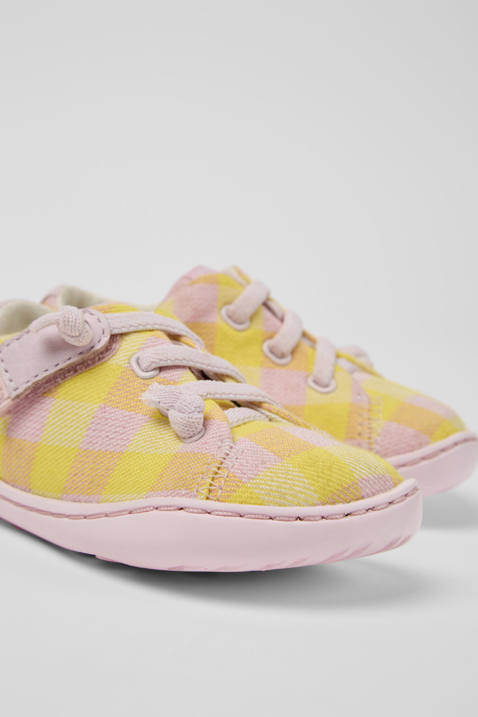 Close-up view of Peu Pink and yellow shoes for kids