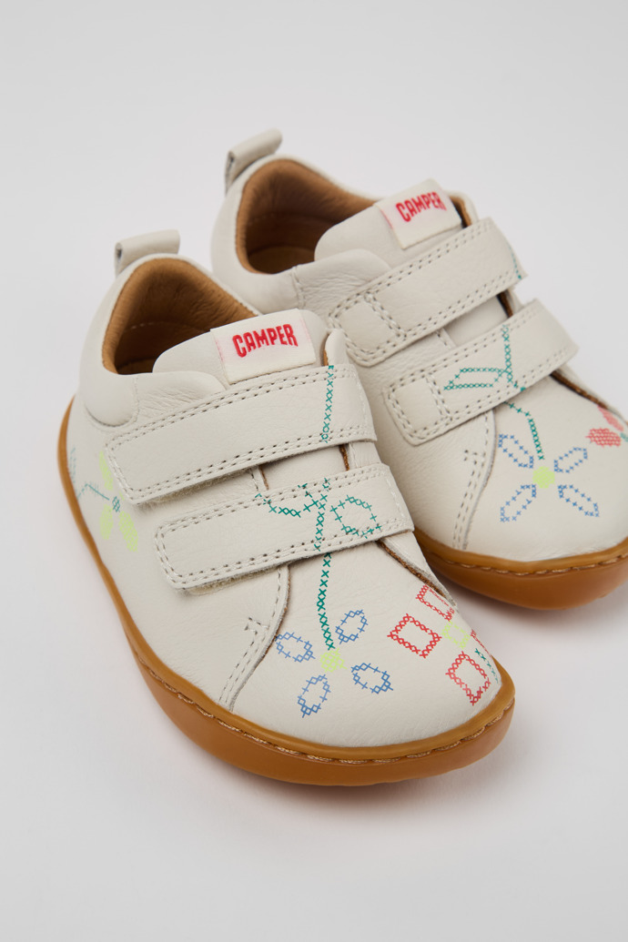 Close-up view of Twins White Leather Kids' Sneakers.