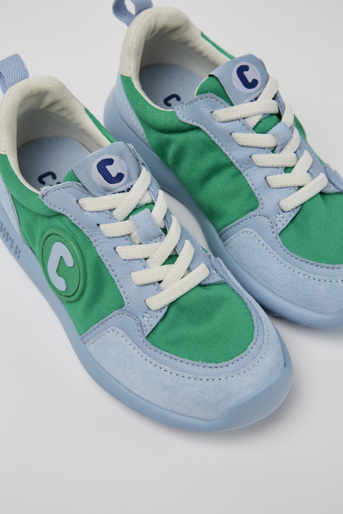 Close-up view of Driftie Green, blue, and white sneakers for kids