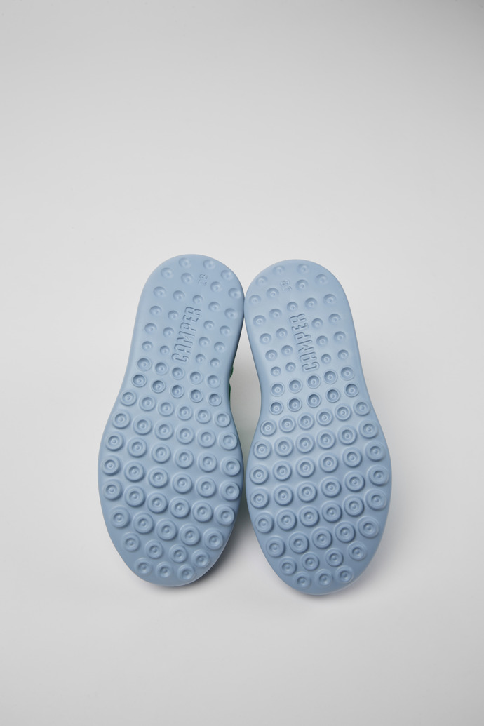 The soles of Driftie Green, blue, and white sneakers for kids