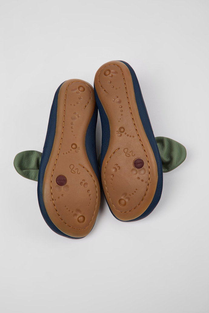 The soles of Right Blue and green leather ballerinas for kids