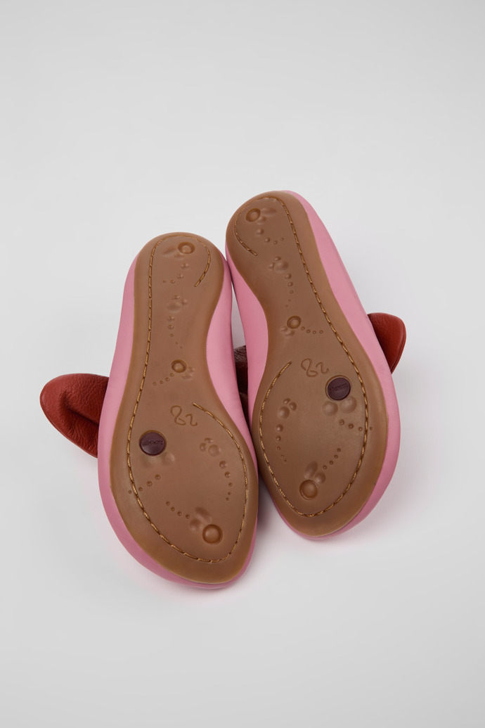 The soles of Right Pink and red ballerinas for kids