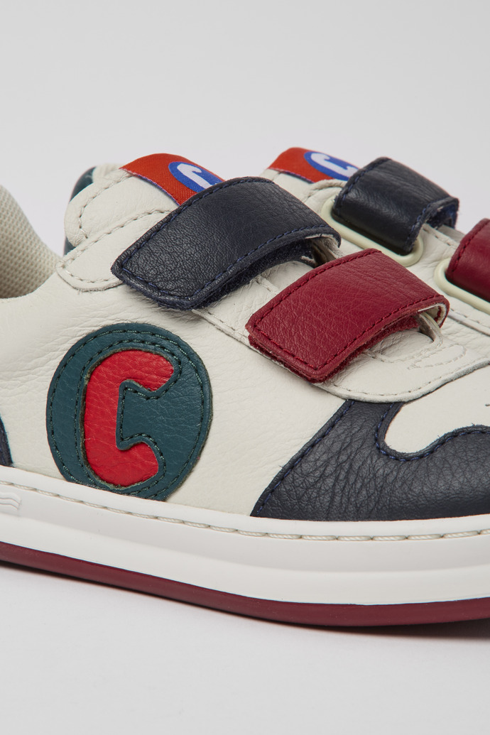 Close-up view of Runner White, blue and red sneakers