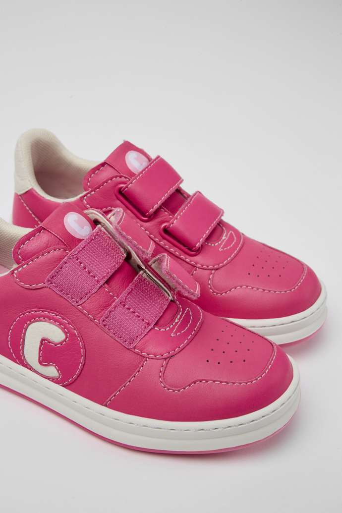 Close-up view of Runner Pink and white leather sneakers for kids