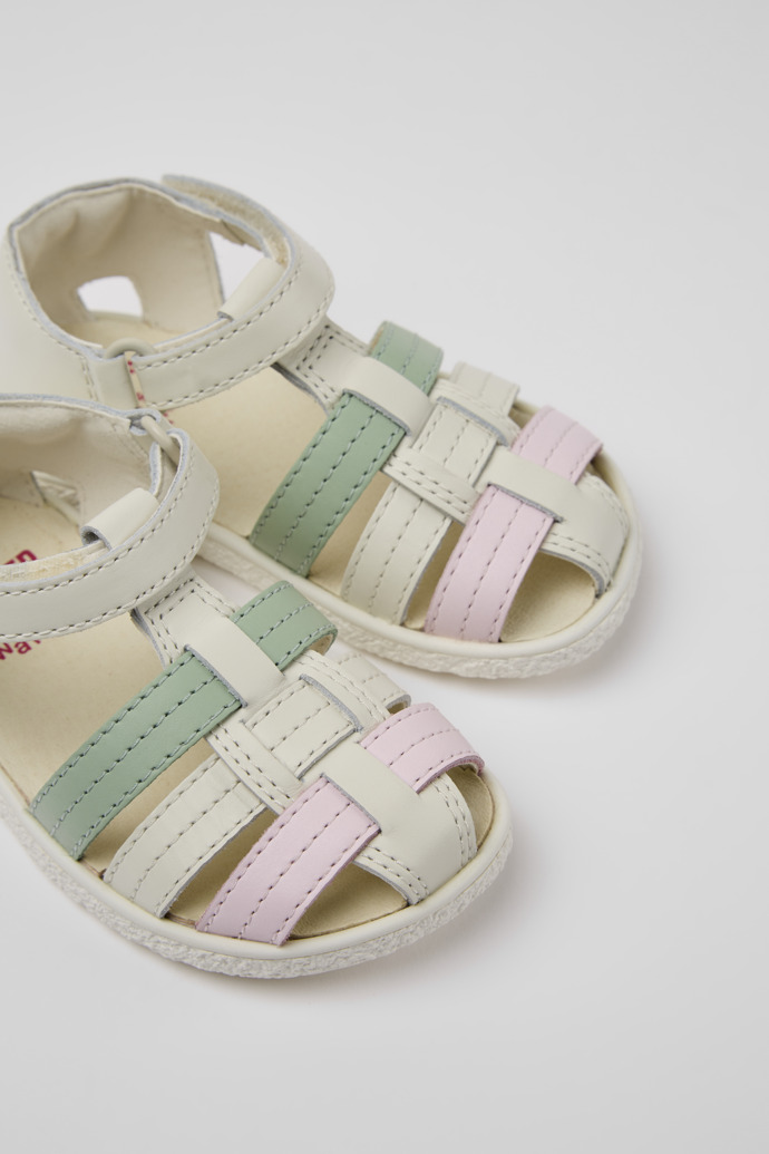 Close-up view of Miko White, green, and pink leather sandals