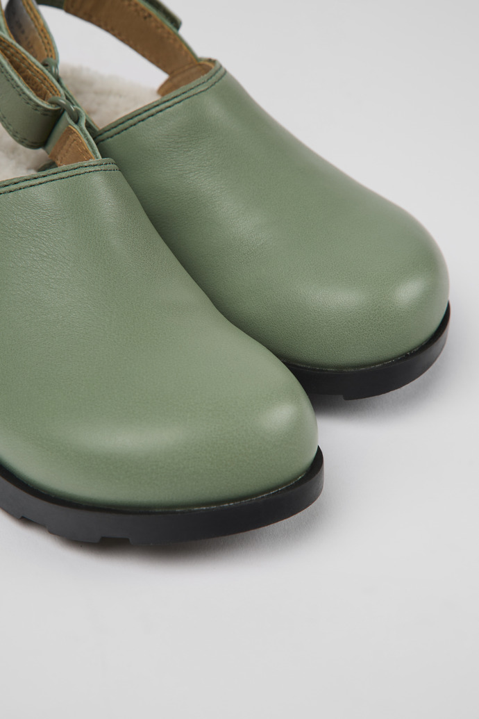 Close-up view of Brutus Green leather clogs for kids