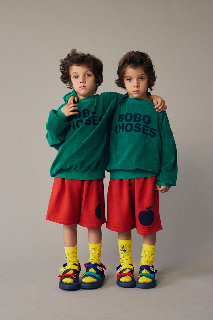 A model wearing Bobo Choses x Camper Multicolor Textile Sandals for Kids.