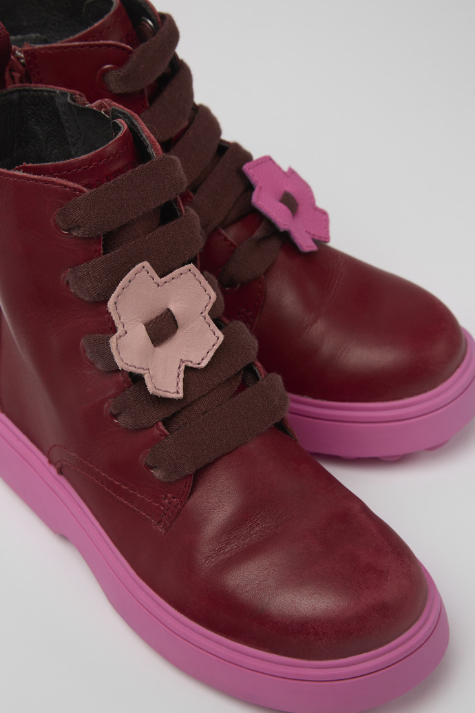 Close-up view of Twins Burgundy and pink leather lace-up boots
