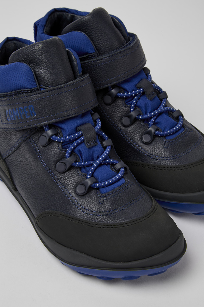 Close-up view of Peu Pista Black and blue ankle boots