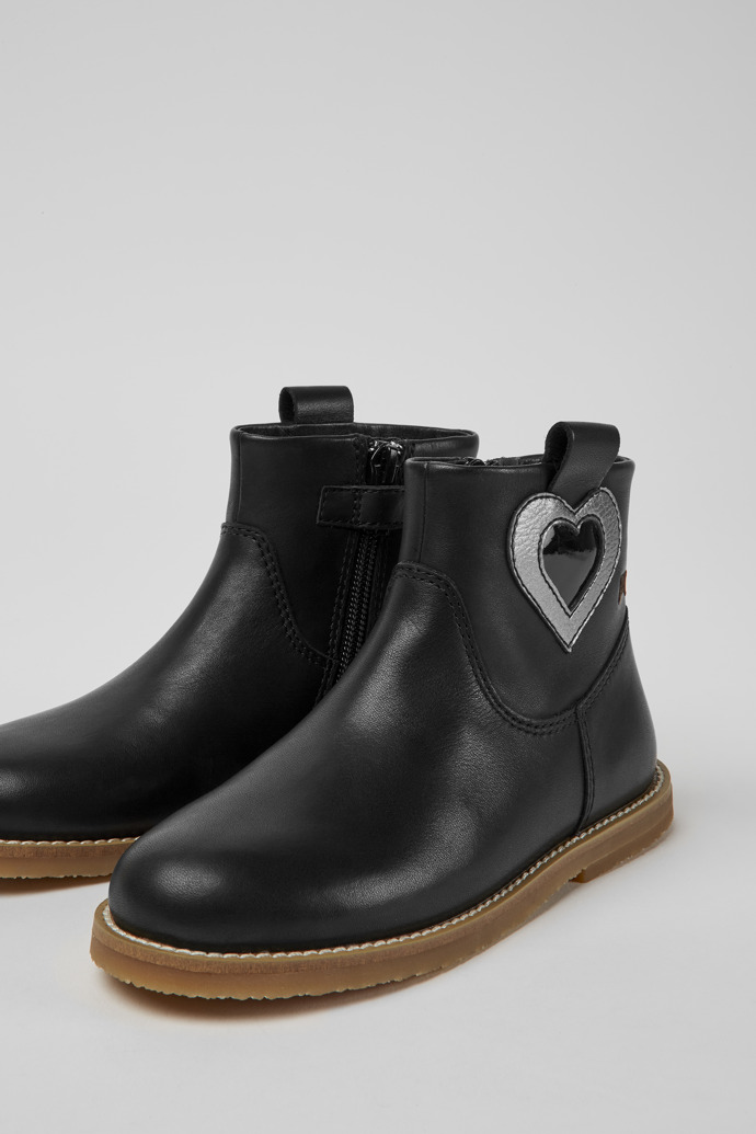 Close-up view of Twins Black leather ankle boots