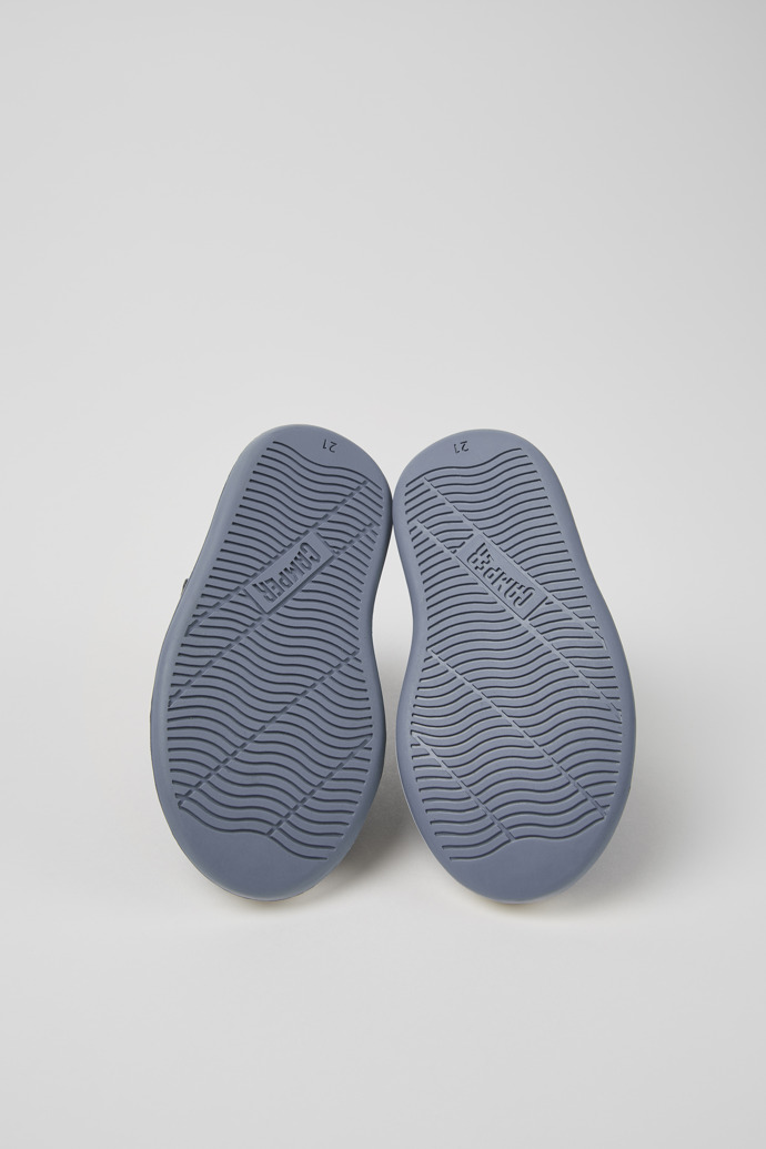 The soles of Runner Blue and gray leather sneakers for kids