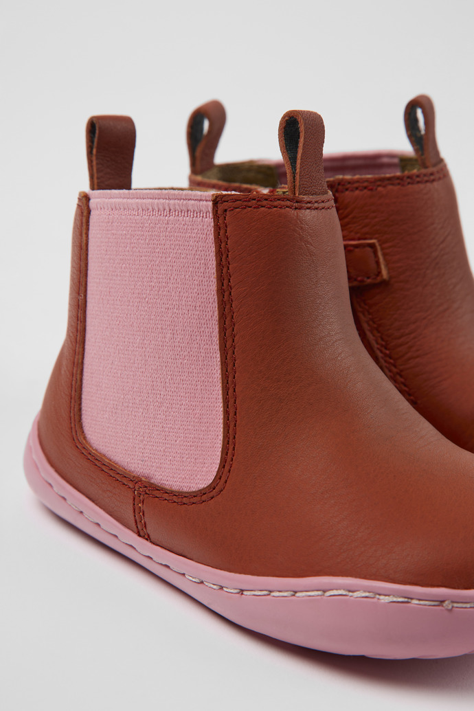 Close-up view of Peu Red and pink leather boots for kids