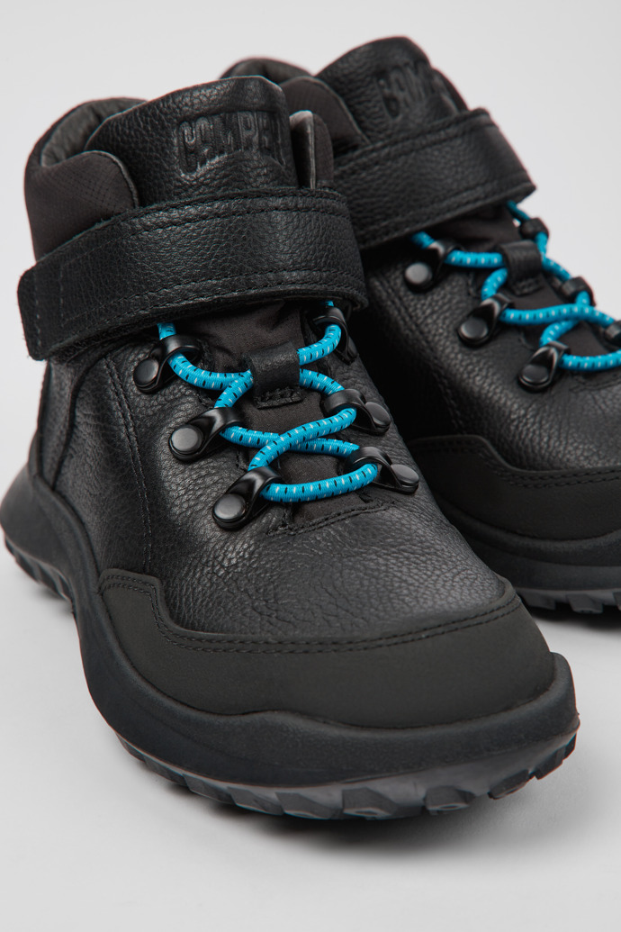 Close-up view of CRCLR Black leather and textile ankle boots for kids