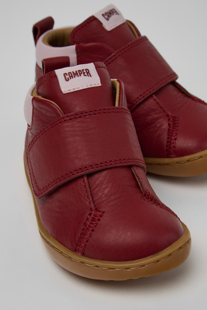 Close-up view of Peu Burgundy and Pink Leather Ankle Boots for Children.