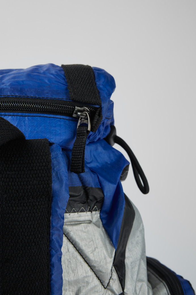 Close-up view of Camper x North Sails Blue, silver, and black backpack