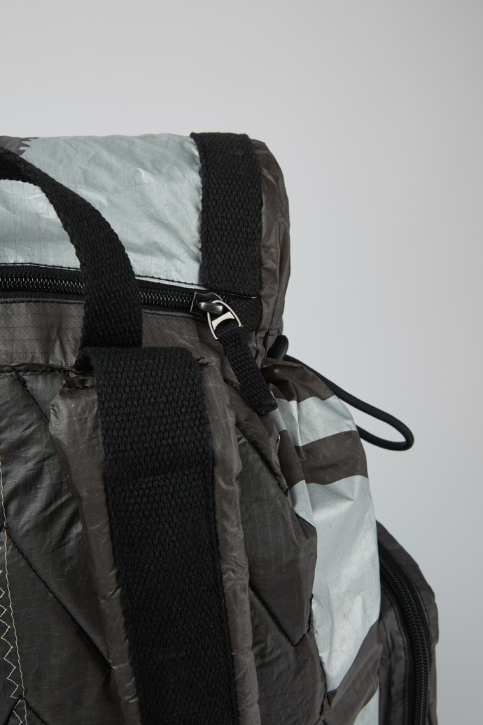 Close-up view of Camper x North Sails Green, gray, and silver backpack