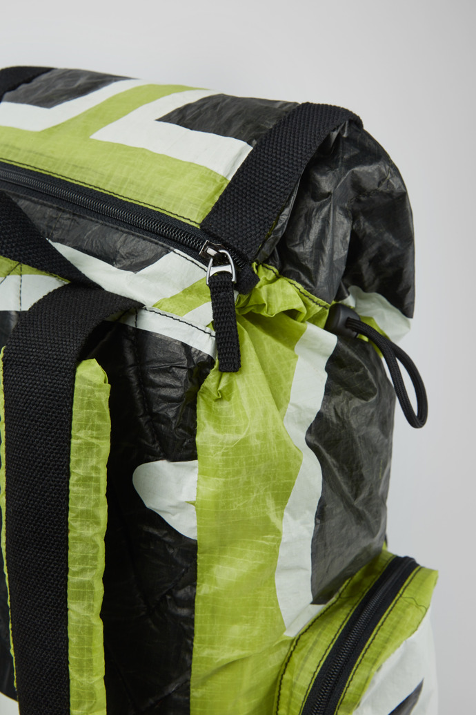 Close-up view of Camper x North Sails Green, black, and white backpack