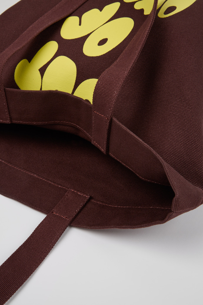Close-up view of ConMigo Burgundy and yellow tote bag