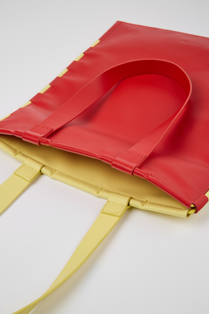 Close-up view of Tie Bags Red and yellow flat tote bag