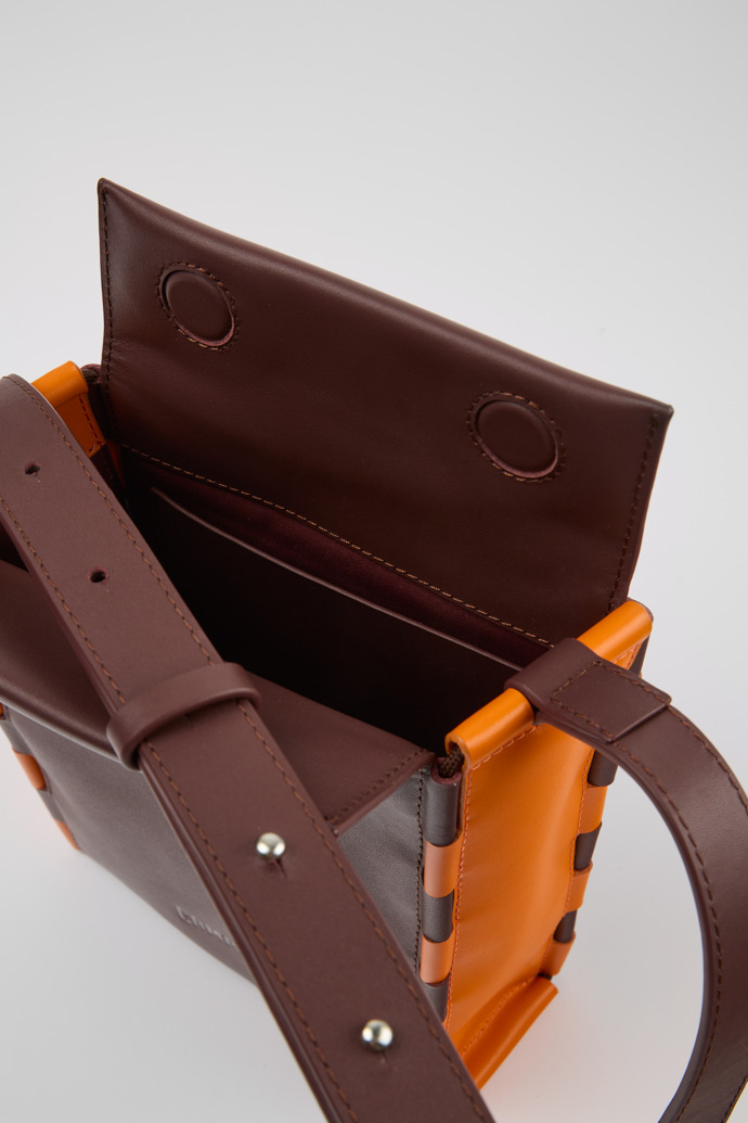 Close-up view of Tie Bags Burgundy and orange crossbody bag