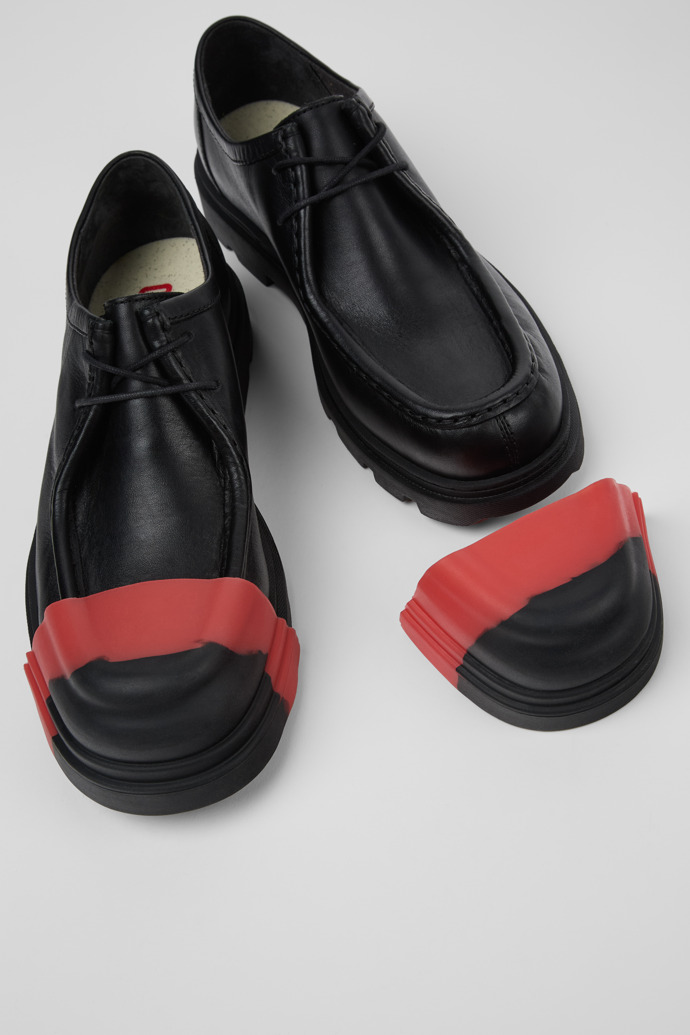 Close-up view of Junction Toe Caps Black, red rubber toe caps