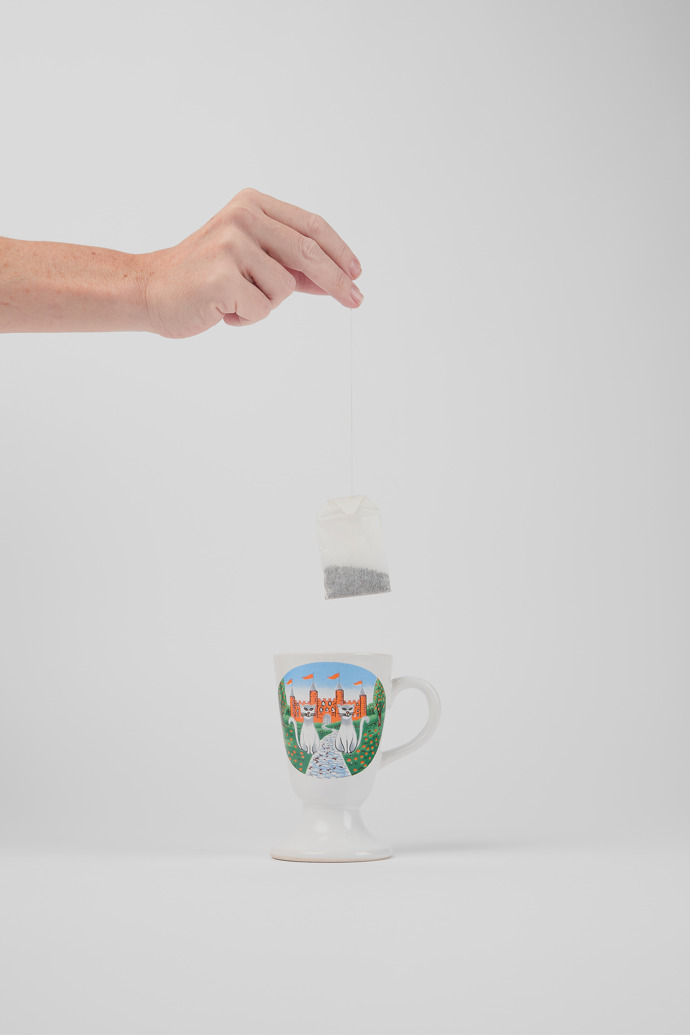 A model wearing Vintage cup Small white ceramic cup with illustration