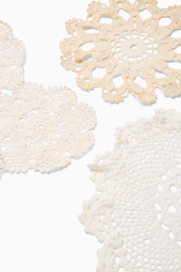 Close-up view of White handwoven doilies Handmade white and beige doilies