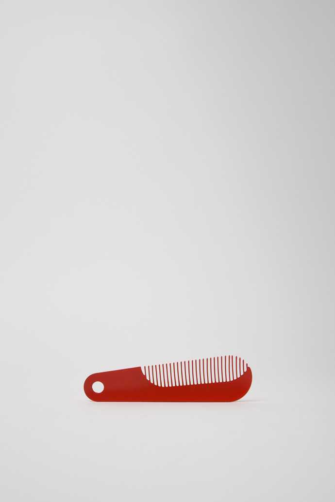 Side view of Camper Combi by Martí Guixé Red comb and shoe horn