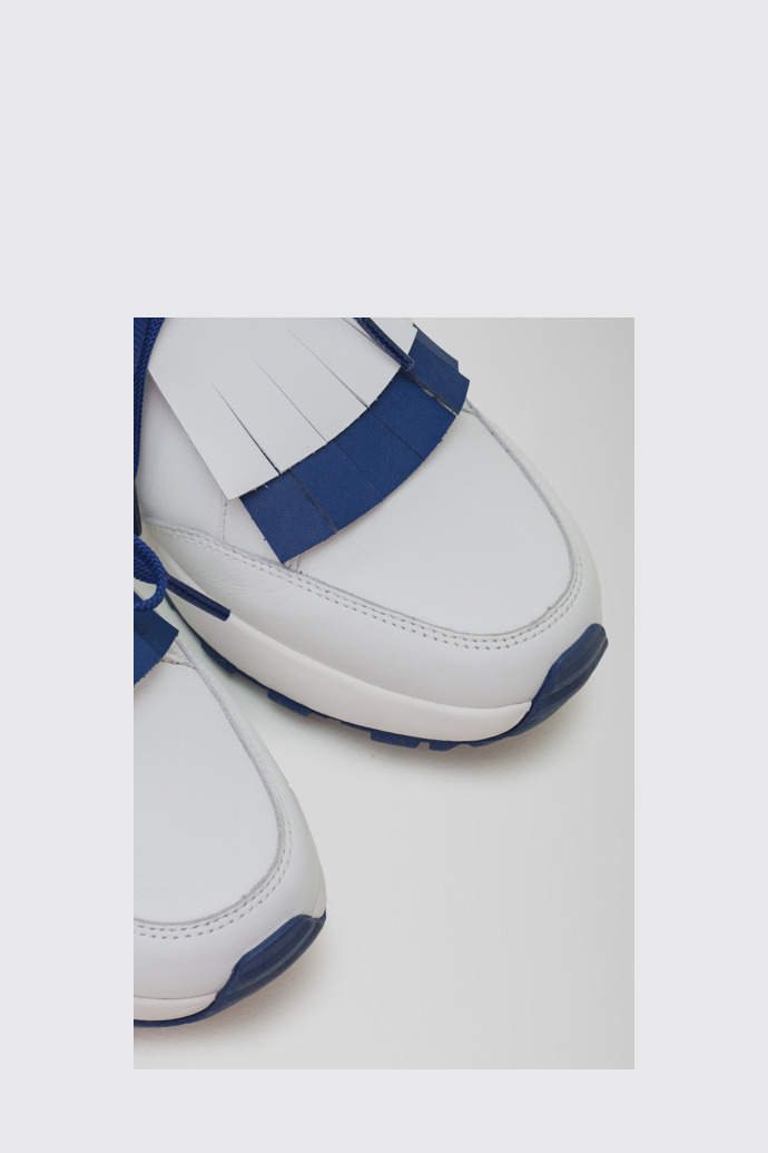 Close-up view of Spackler White and navy leather golf sneakers